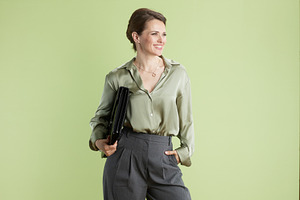 Confident professional woman with portfolio, a Person Photo by Alliance Images