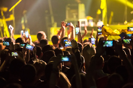 Crowd at concert and blurred stage lights  featuring crowd, people, and event