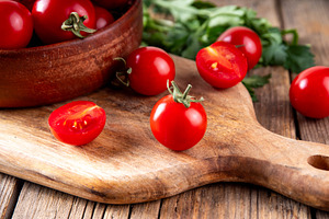 Bowl with tomatoes on wooden background, a Food & Drink Photo by Rimma