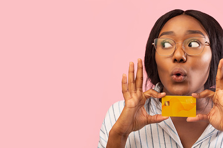 Funny Lady Holding Credit Card Near Face, Pink Background, Panorama, a Person Photo by Prostock-Studio