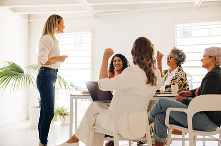 Happy businesswomen celebrating during a meeting, a Person Photo by Jacob Lund