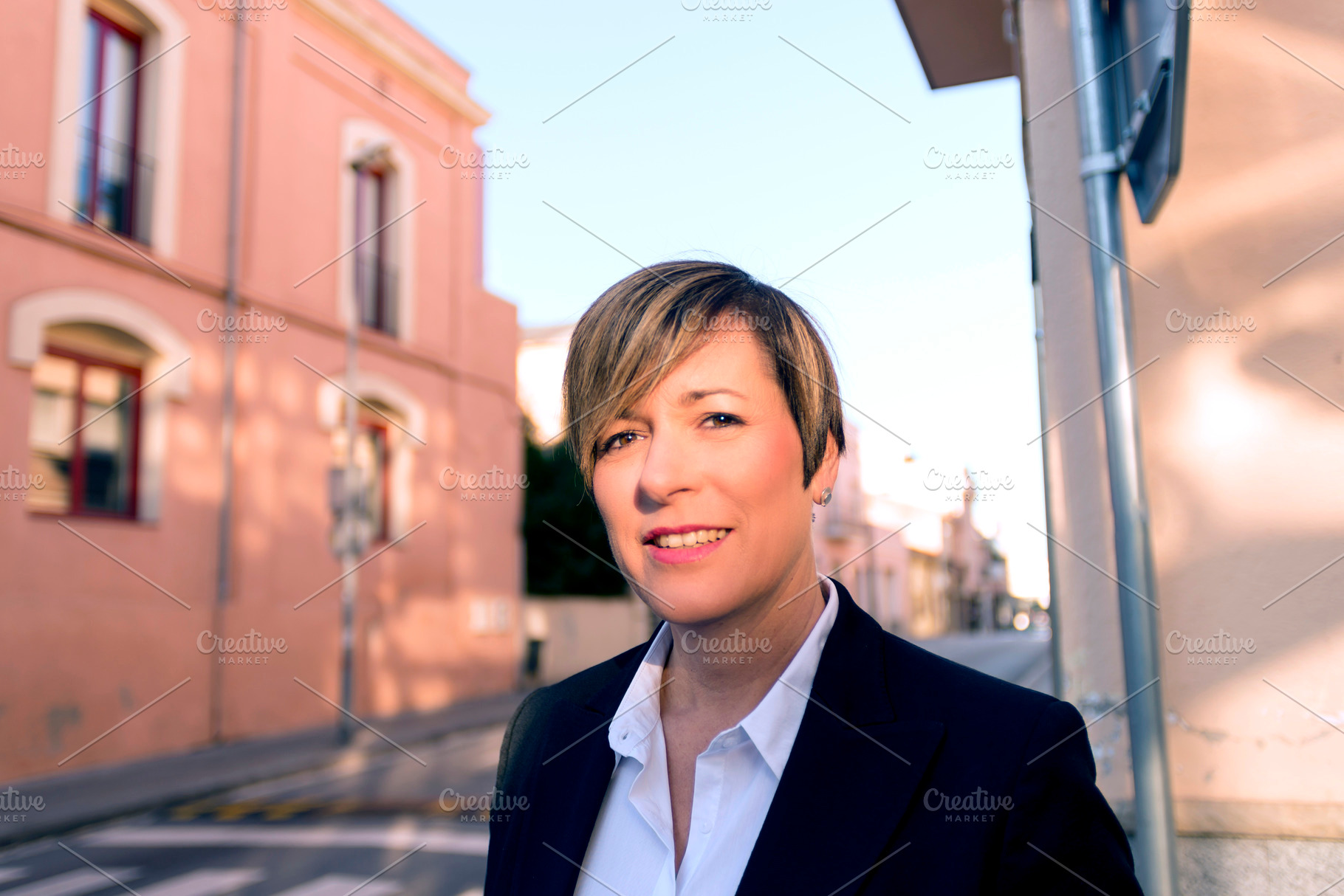 Portrait of businesswoman in urban street, a Photo by RF Images