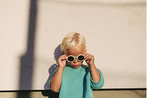 Smiling blond child wearing round, a Nature Photo by HalfPoint