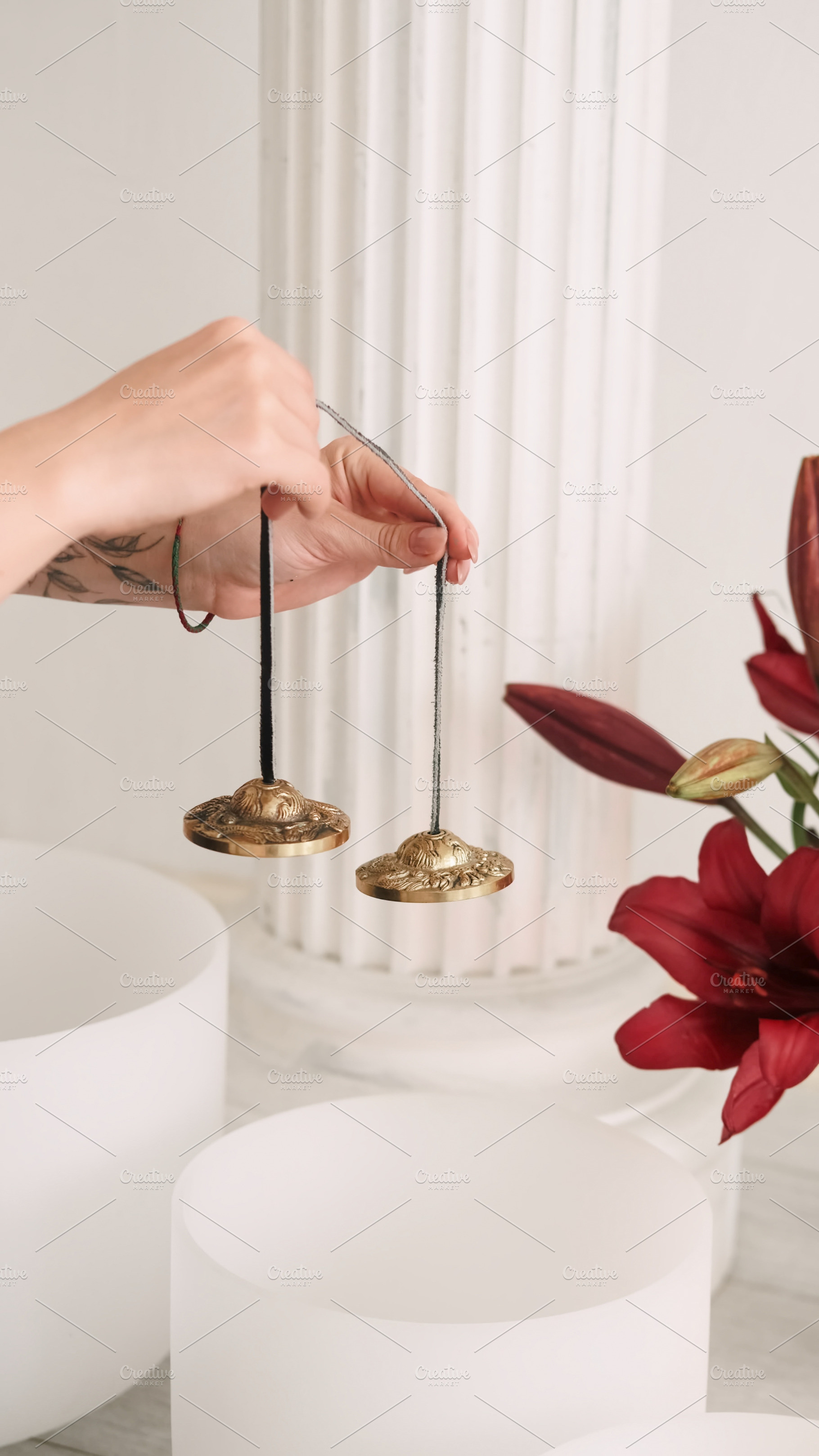 Tingsha bells sound meditation hand, a Person Photo by Photo Drive Studio