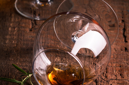 Glass of brandy or cognac featuring action, alcohol, and background, a Food & Drink Photo by piter.goskov