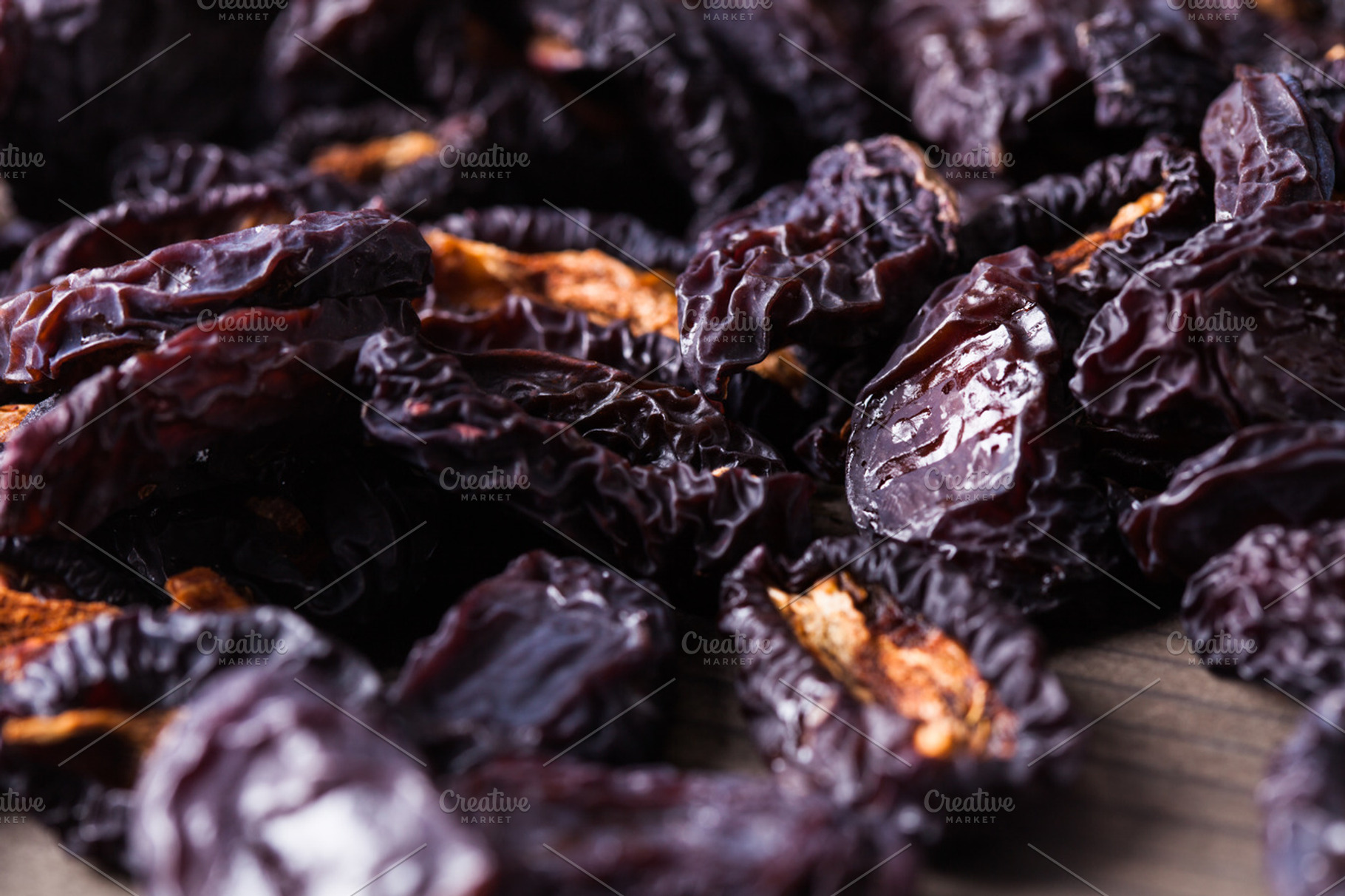 Slices of dried plums closeup containing autumn, background, and blue, a Food & Drink Photo by oksix