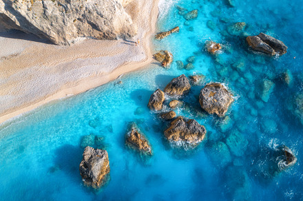 Aerial view of blue sea, rocks in clear water, white sandy beach, a Nature Photo by den-belitsky