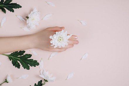 Female hand with white flowers containing creative, beauty, and female, a Beauty & Fashion Photo by Yura_Yarema