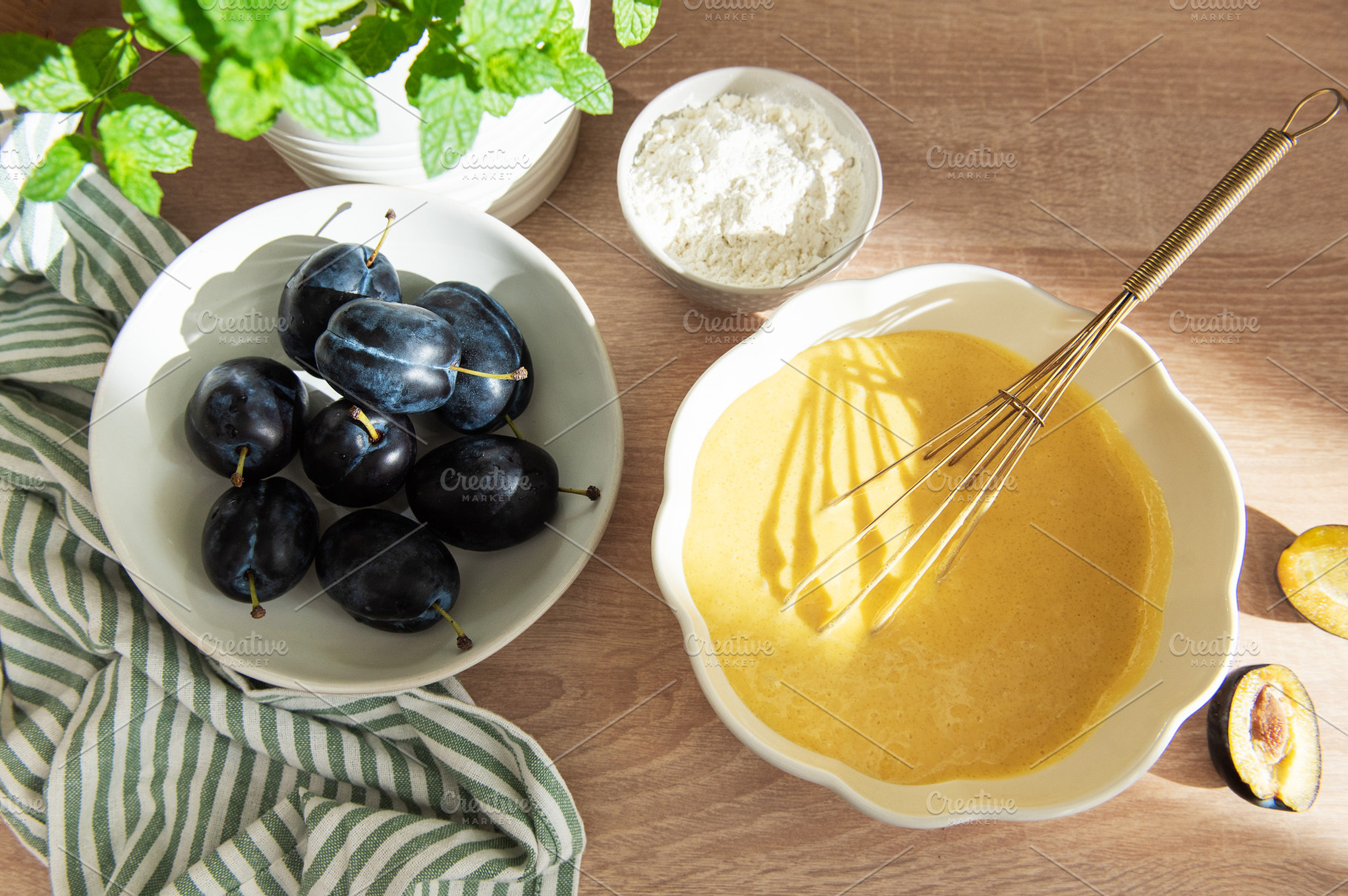 Baking plum cake ingredients with batter and flour, a Food & Drink Photo by Olena Rudo