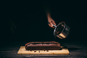 Pouring chocolate on a cake