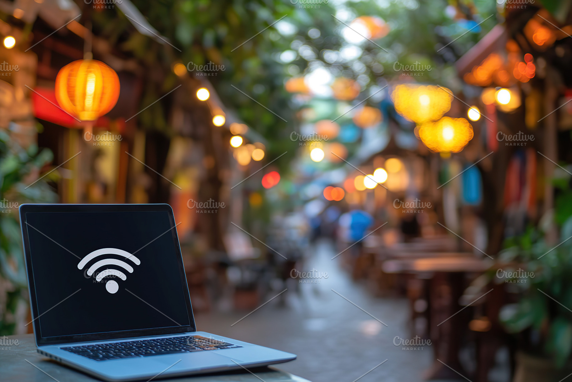 Laptop displaying wifi sign in a vibrant outdoor cafe setting du, a Technology Photo by AlyaAnd