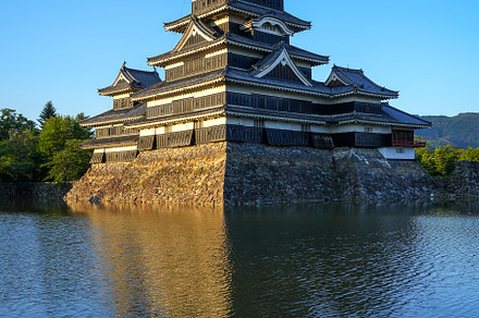 Matsumoto Castle reflecting in the water at sunset, Japan