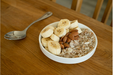 Oatmeal with banana, honey and, a Food & Drink Photo by oksix