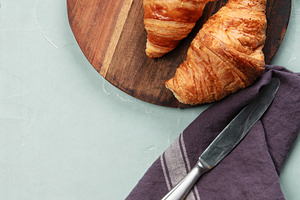 Fresh Croissants on Wooden Board with Butter and Knife, a Food & Drink Photo by Natalia Klenova's Shop