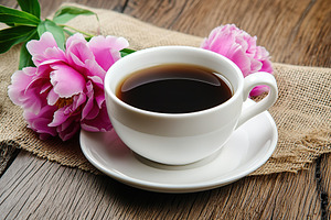 Cup of hot coffee with pink peony flowers, a Food & Drink Photo by AlyaAnd