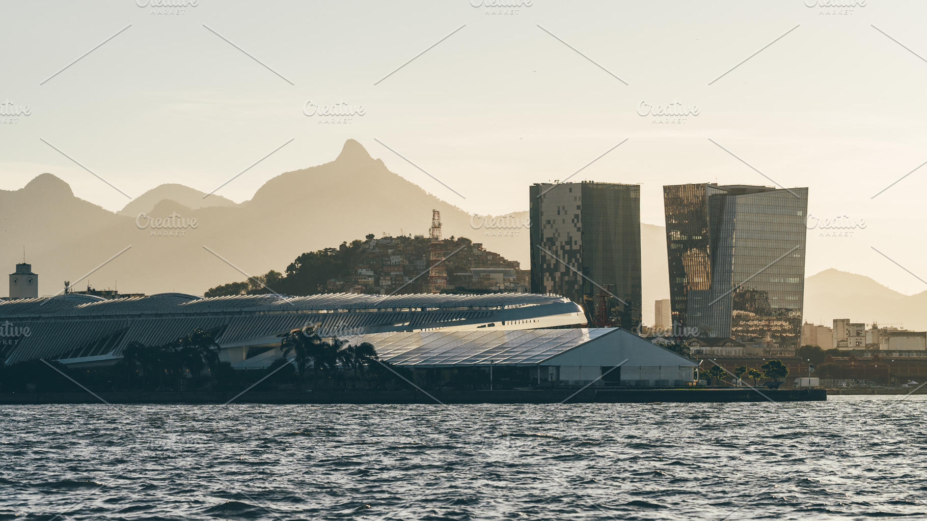 Sunlit skyline by coastal water, an Architecture Photo by SkyNext