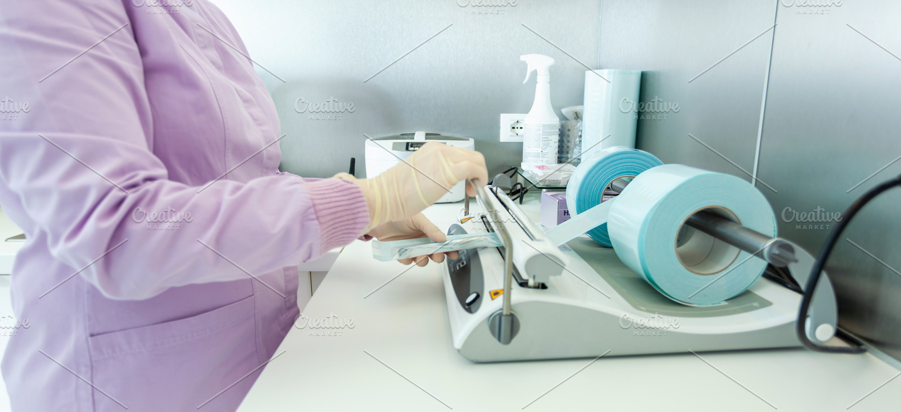 Nurse packing medical instruments for sterilization in a vacuum packing machine, a Health & Medical Photo by Antonio Gravante Market