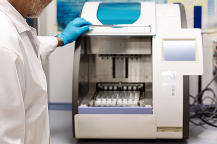 Scientist operating an automated sam