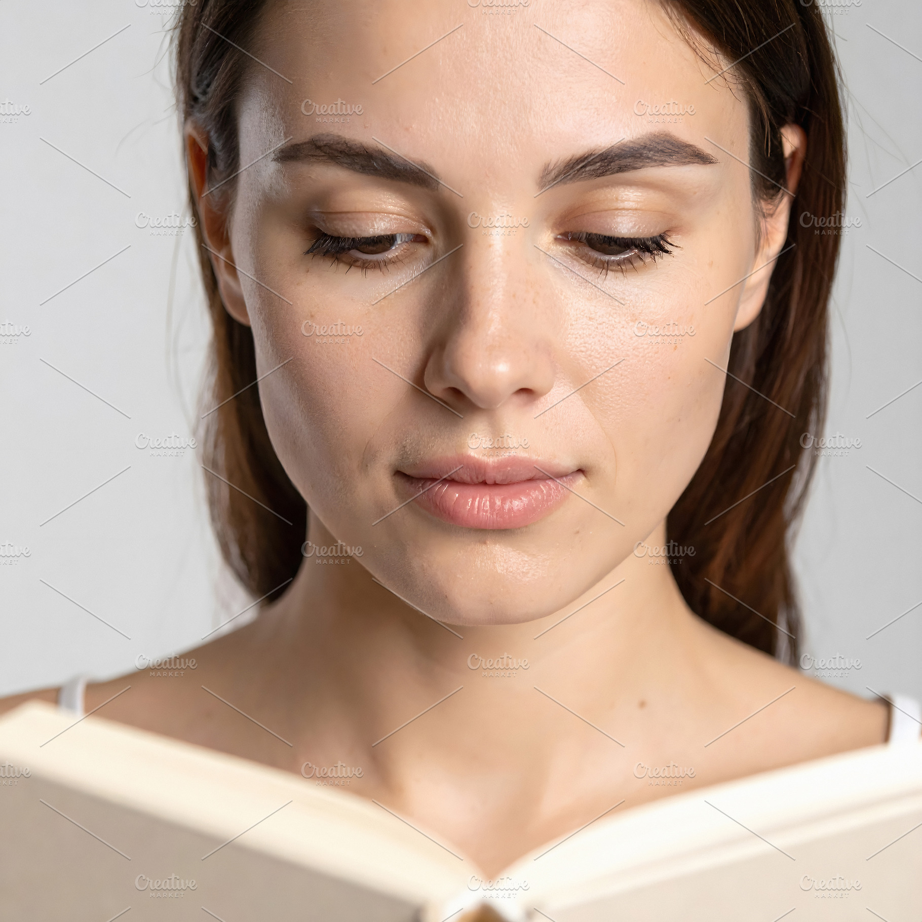 Woman reading book portrait with serene attention, a Person Photo by GoodGoods