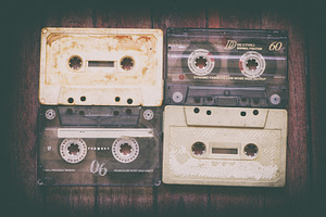 Old cassette tapes on the wooden tab stock photo containing 80 and 80s