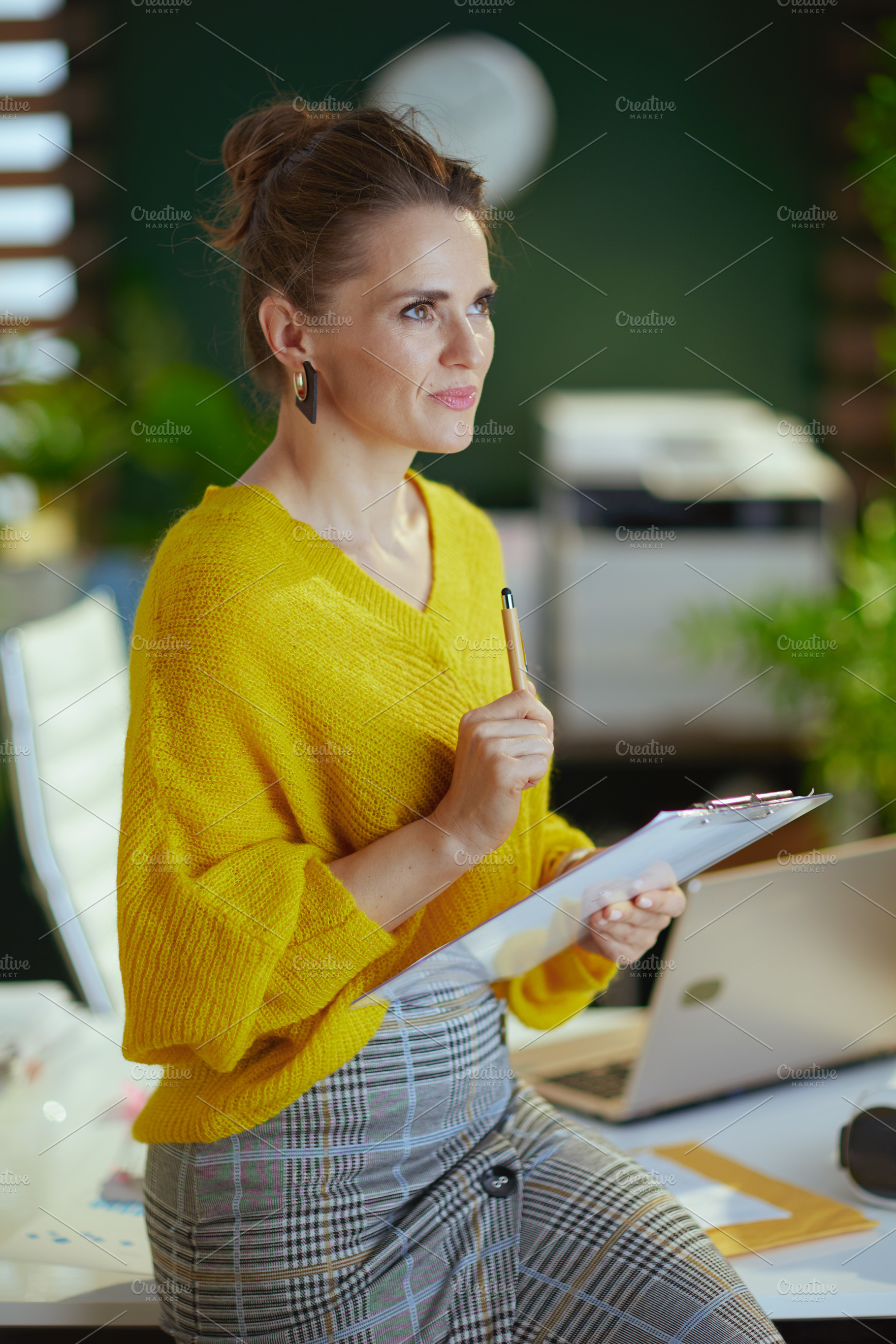 trendy business owner woman in sweater in green office, a Business Photo by Alliance Images
