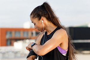 Woman checking her phone on band, a Sports & Recreation Photo by Artem Varnitsin