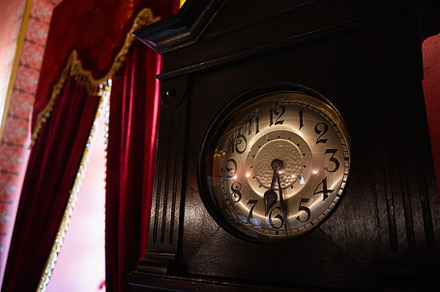 Antique clock in an elegant room with vintage decor and red curtains, a Photo by AS photostudio