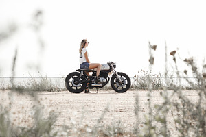 Woman and motorcycle on road stock photo containing background and retro, a Transportation Photo by Aliaksei Kaponia