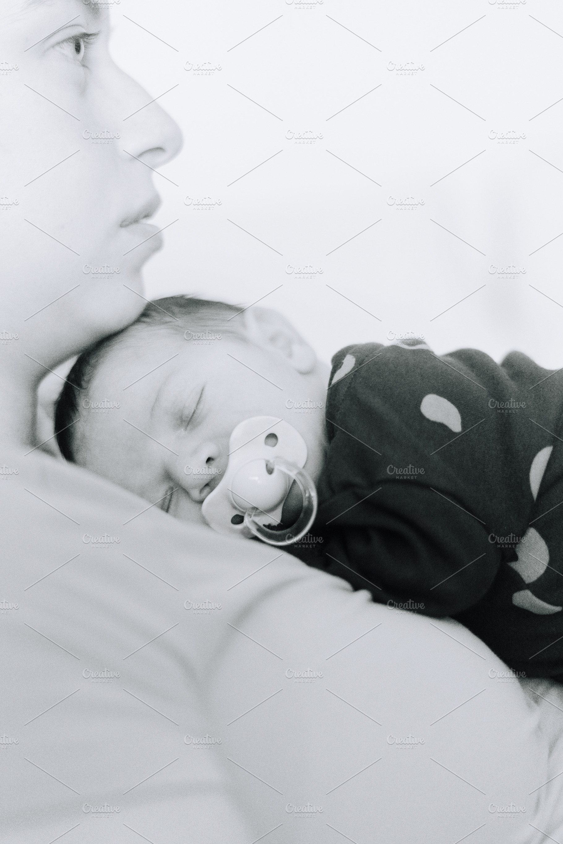 A newborn baby asleep on his mothers chest, a Person Photo by rubenchase