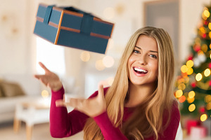 Young woman showing excitement and happiness, catching a flying, a Person Photo by Studio ANNA