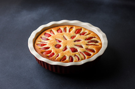 Homemade plum pie with almond flour in ceramic baking pan, a Food & Drink Photo by serkum