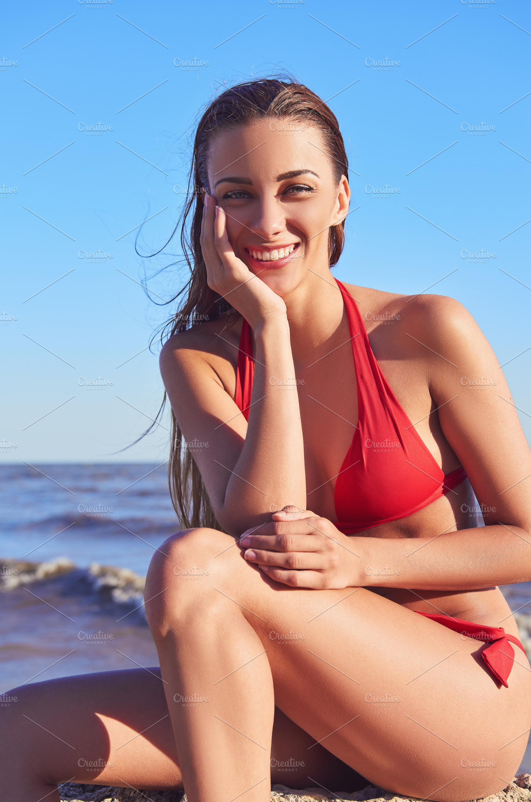 Smiling young girl in red swimsuit, a Person Photo by Jetrel