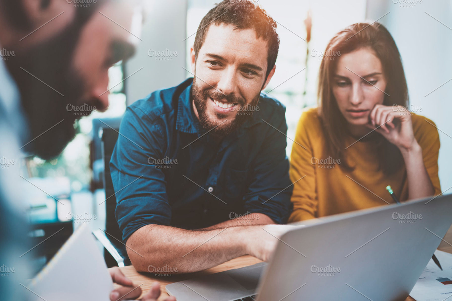 Teamwork concept.Coworking process at sunny loft office.Young Business team making conversation at meeting room.Horizontal.Blurred background., a Business Photo by SFCRCH MOCKUPS