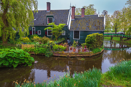 Wooden house with flowery courtyard, an Architecture Photo by Alpine Dreams