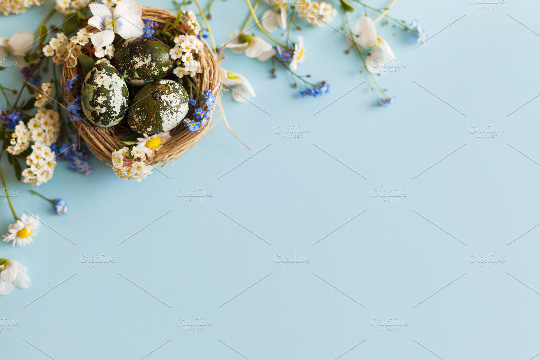 Easter flat lay. Stylish easter eggs and spring flowers in nest, a Holiday Photo by Sonjachni