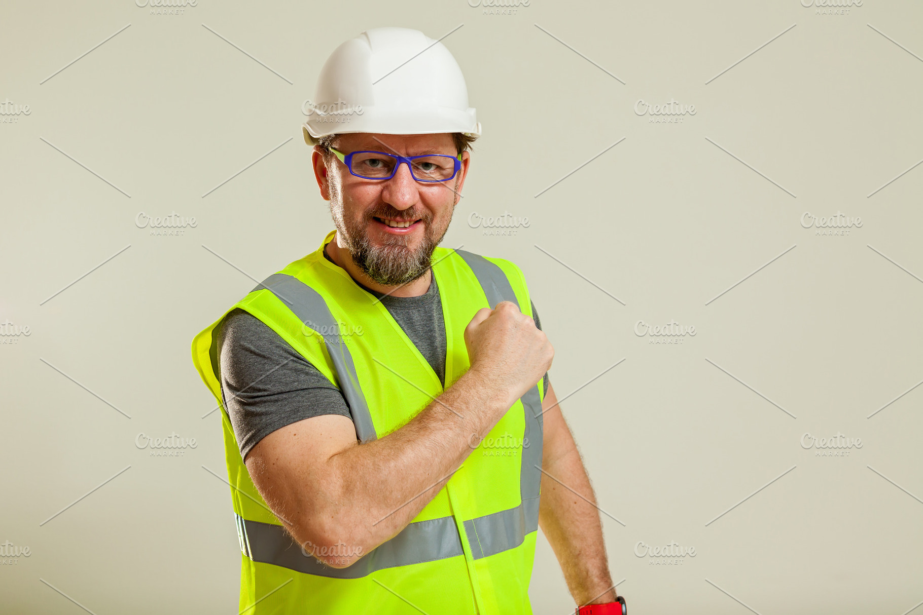 worker in a vest and white helmet, a Person Photo by Photostock