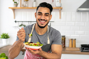 Young Man Eating Fresh Healthy Salad, a Food & Drink Photo by Davizro's Market