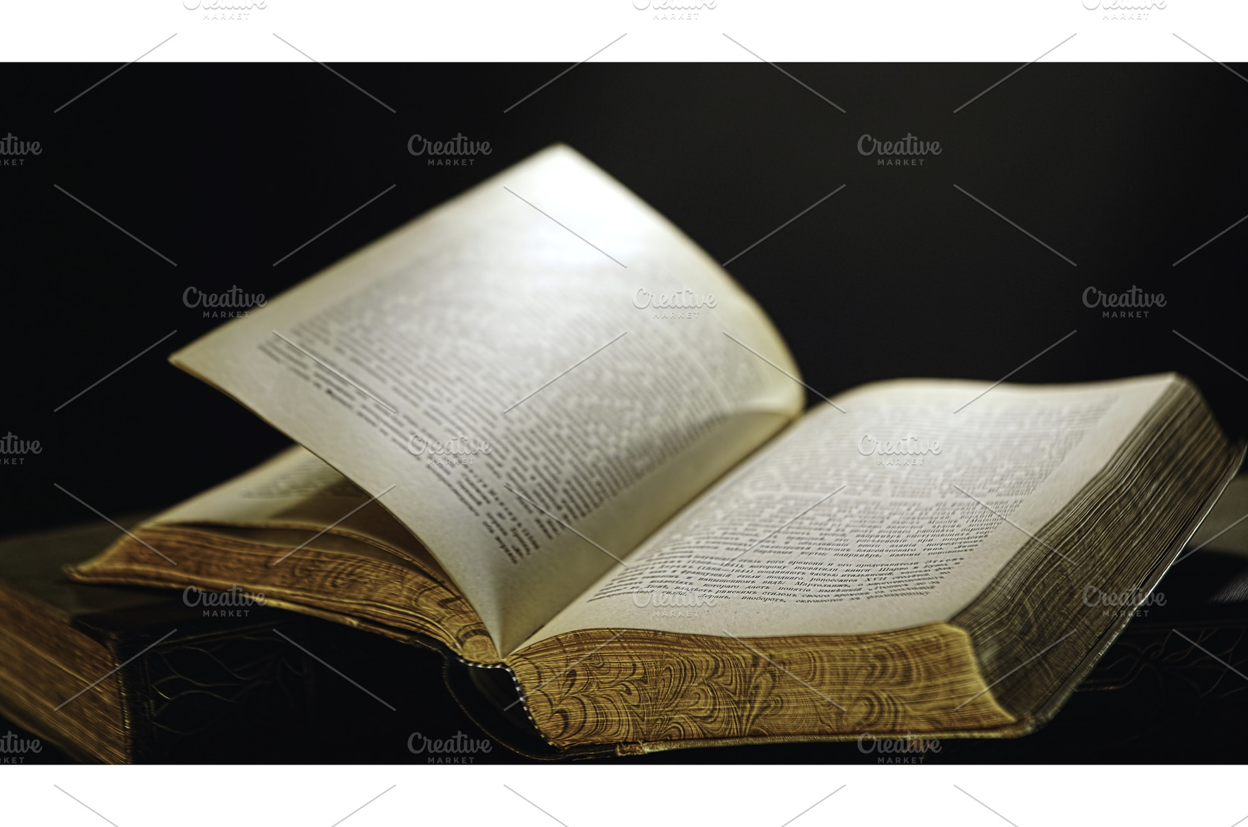 Open old book lying on the table, a School & Education Photo by Media Whale Stock