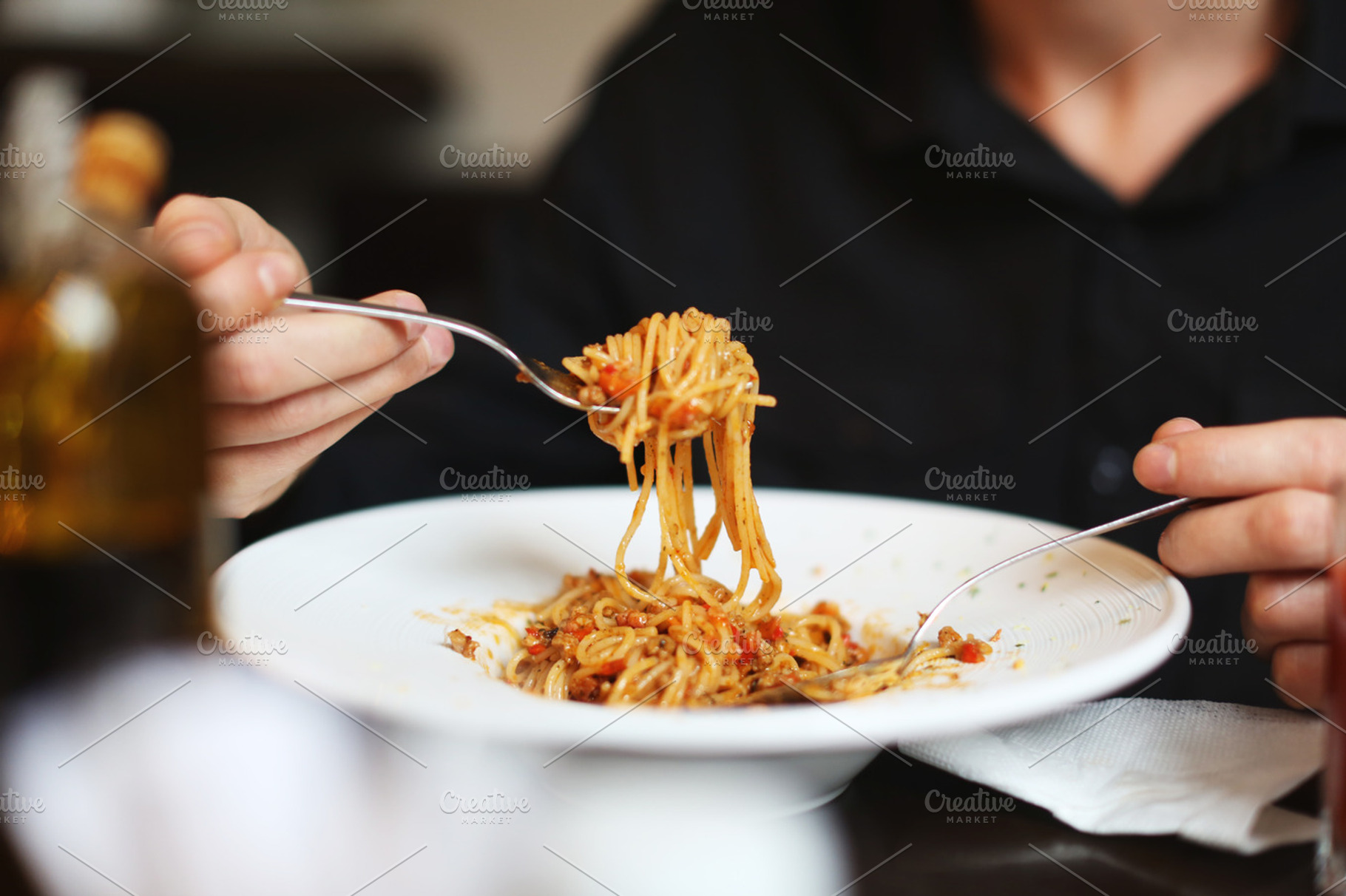 Eating pasta in a restaurant, a Food & Drink Photo by cristinalallare