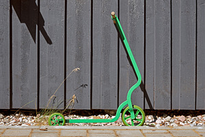 Kick scooter against wooden wall, a Transportation Photo by BOOCYS