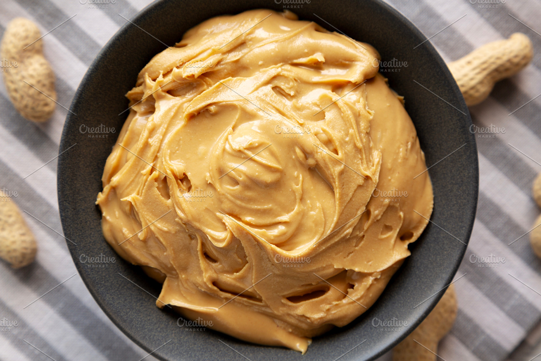 Organic Creamy Peanut Butter in a Bowl, top view., a Food & Drink Photo by LiudmylaChuhunova