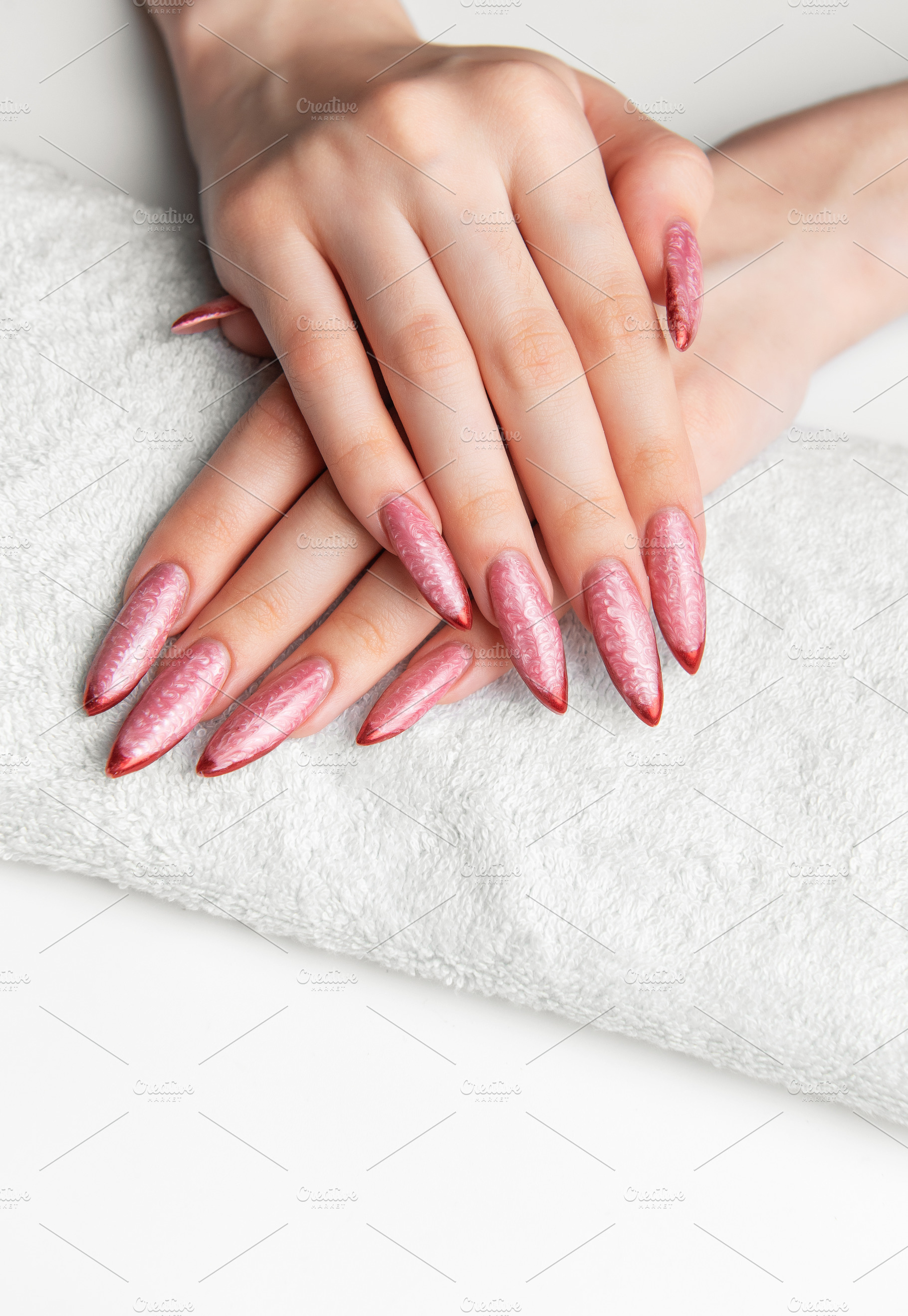 Woman's hands resting on towel with pink stiletto nails, a Beauty & Fashion Photo by Olena Rudo
