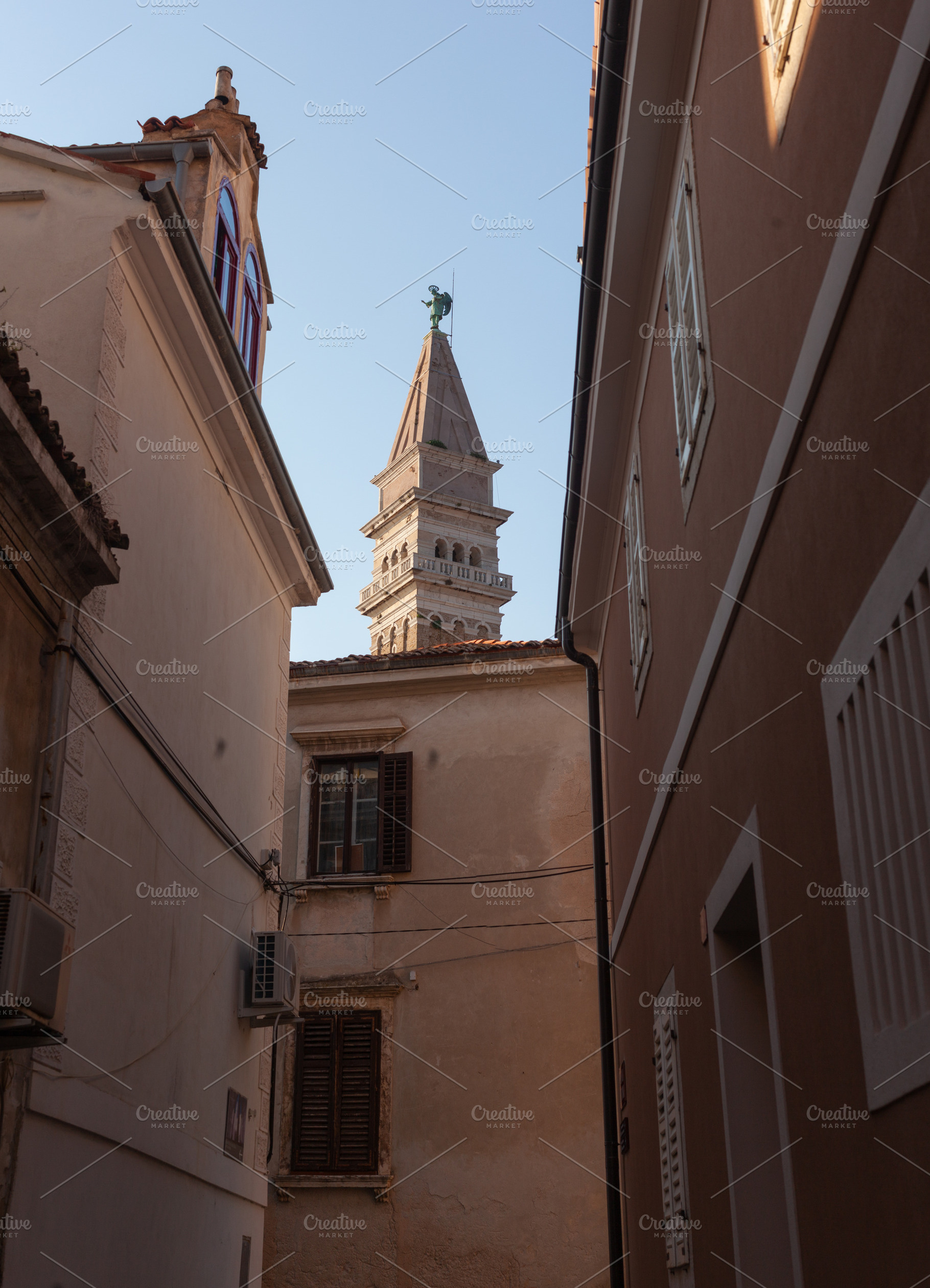 Free standing bell tower of Cathedral of St. Georges between houses, Piran, an Architecture Photo by Bepslabor