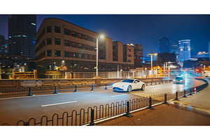 White supercar in fast motion at, a Transportation Photo by Our Amazing World