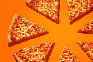 Pizza slices arranging a circular pattern on a vibrant orange ba, a Photo by Studio ANNA