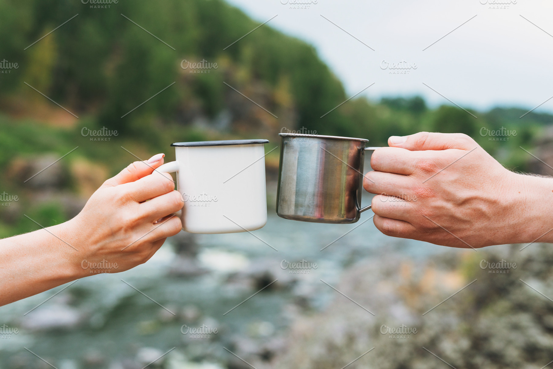 Couple of travelers holding mugs featuring woman, man, and tea, a Person Photo by Galina_Zhigalova