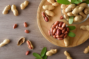 Detail peanut on wooden plate on kitchen bench top view, a Food & Drink Photo by Davizro's Market