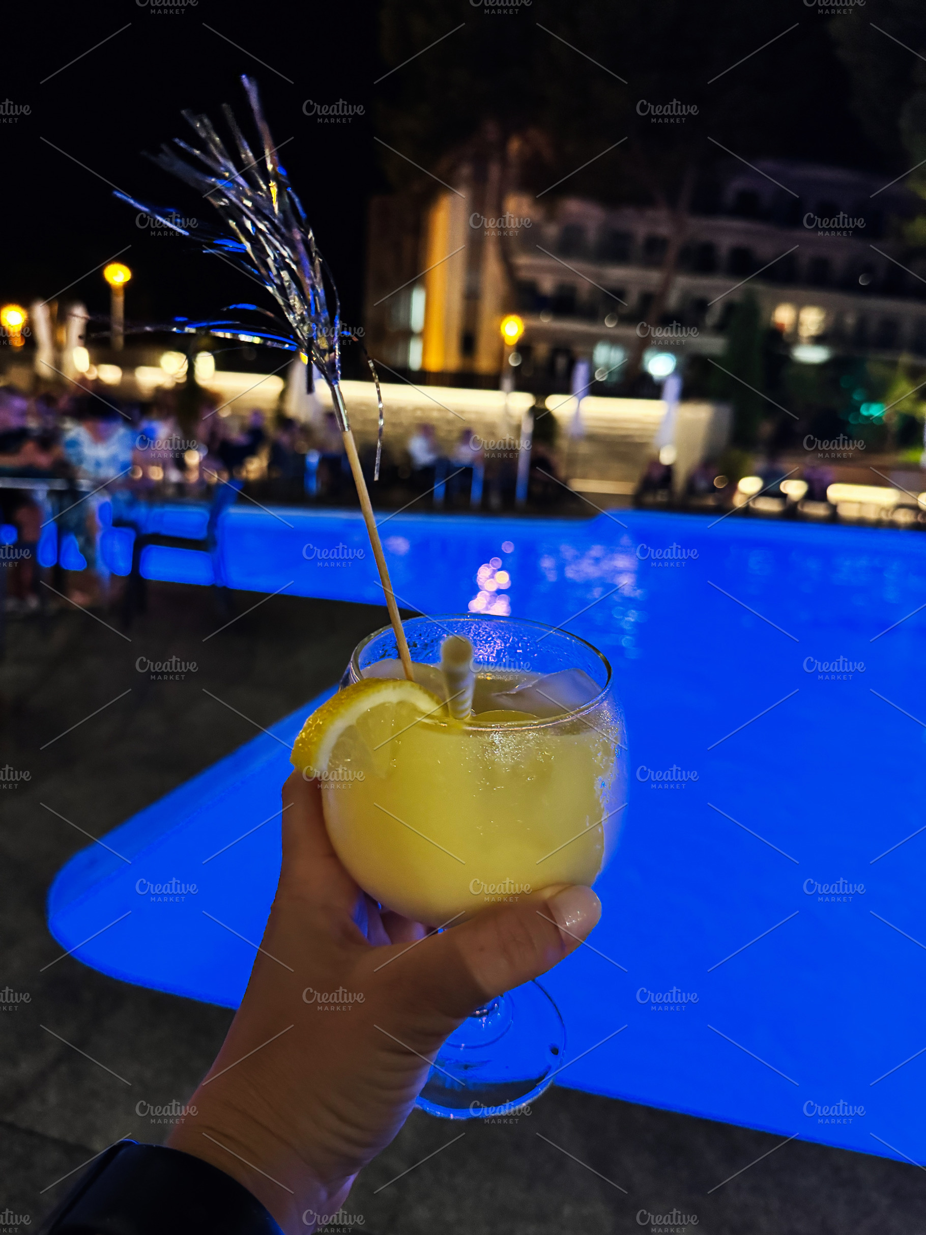 Refreshing cocktail by a luminous pool in a vibrant night atmosphere, a Photo by AS photostudio