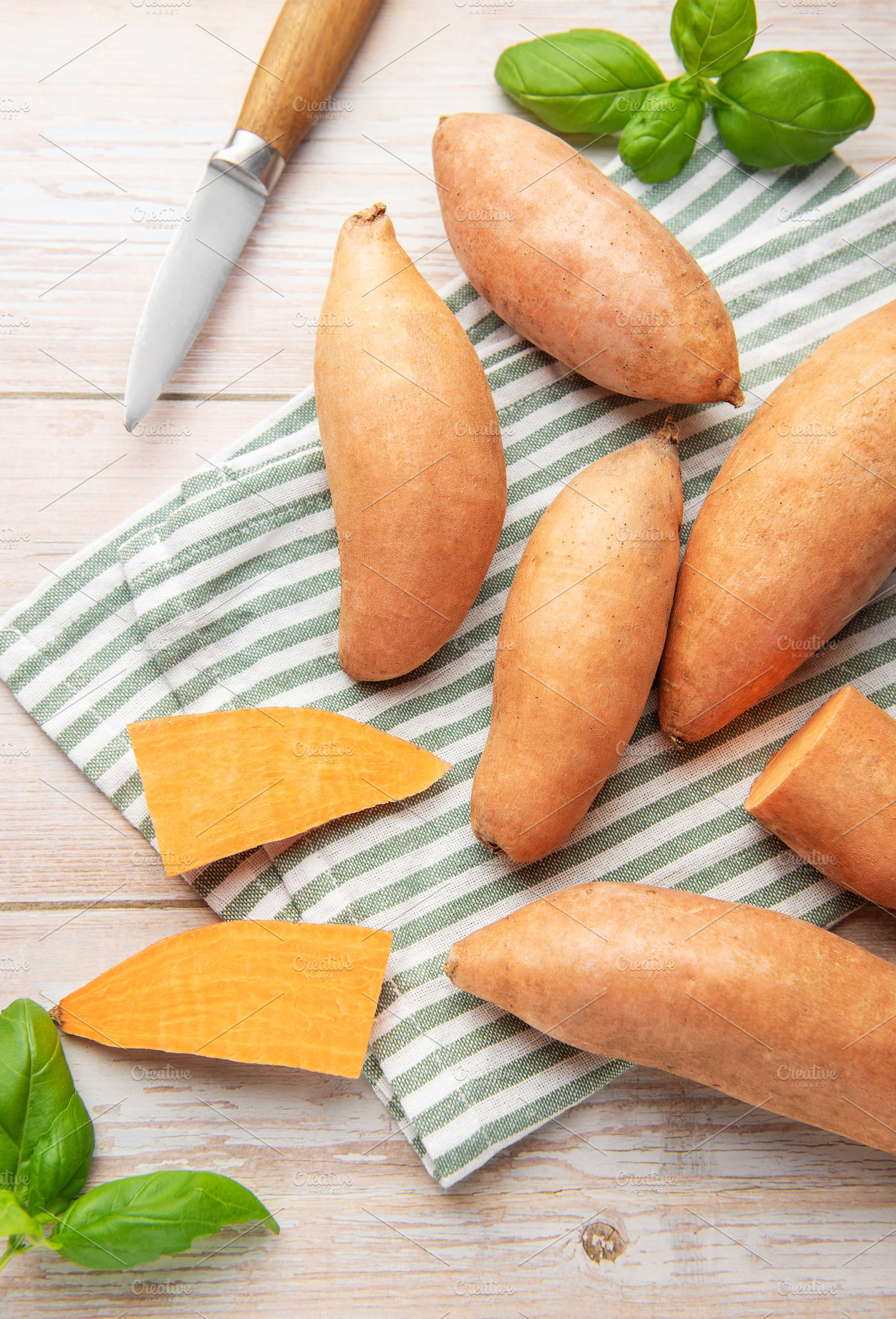 Preparing raw sweet potatoes for healthy cooking, a Food & Drink Photo by Olena Rudo