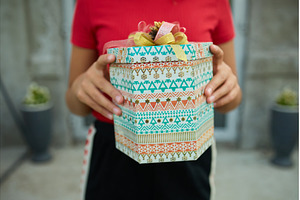 Child holding a wrapped gift outside, a Holiday Photo by IlliaBondarPhotography